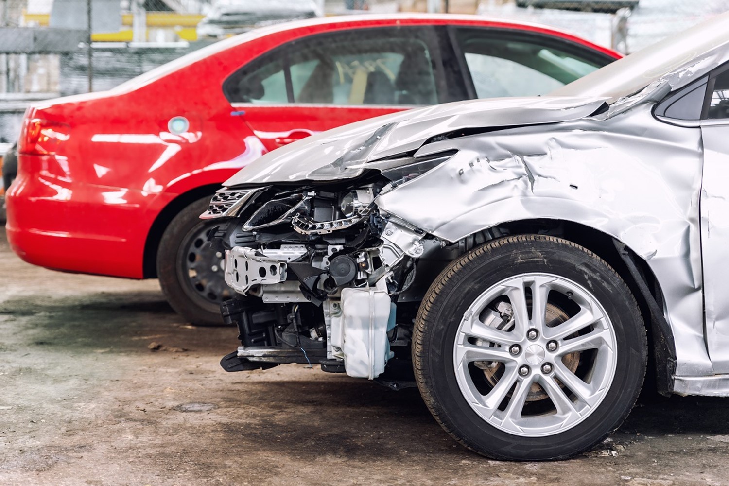 Broken car after a traffic accident in the parking lot of a repair station.  Car body