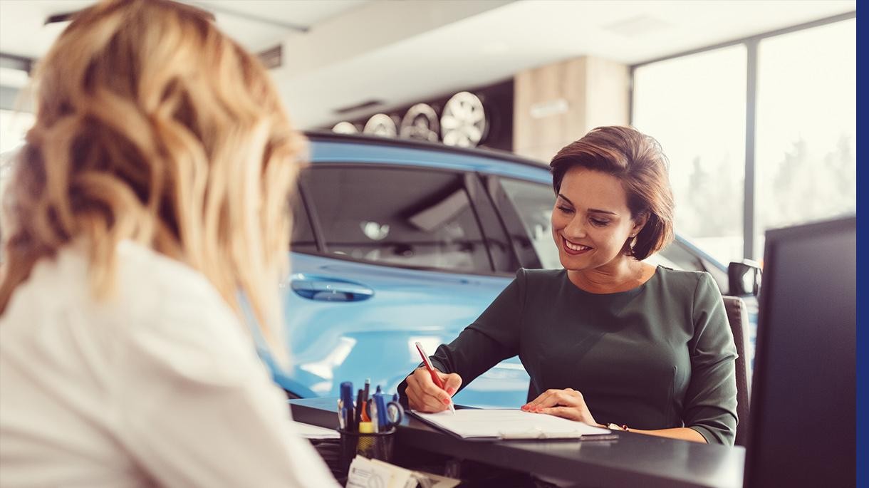 Customer signing document in dealership.