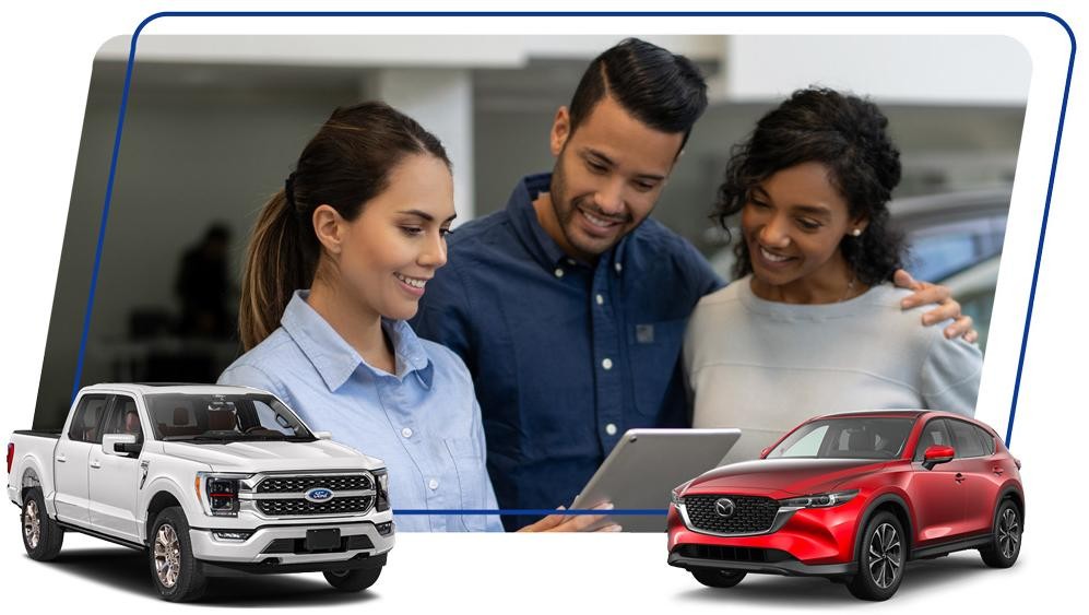 Saleswoman at a car dealership talking to a happy couple