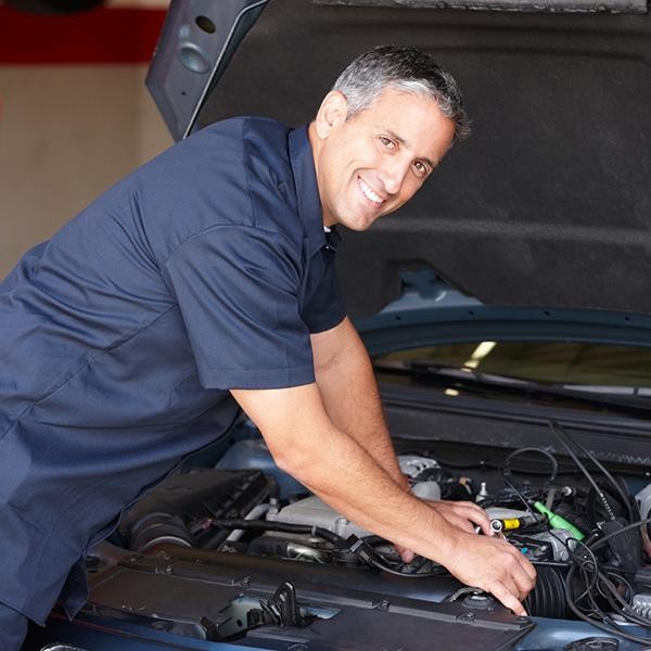 Service technician working on vehicle