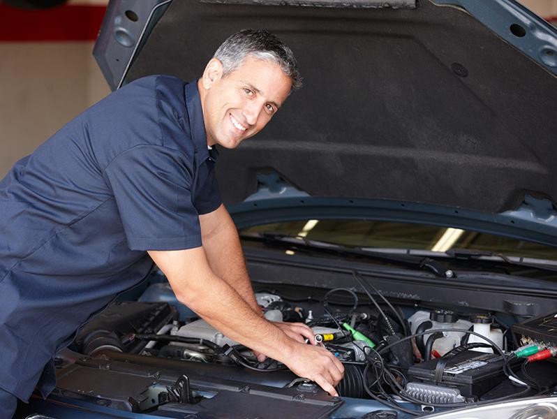 Service technician working on vehicle