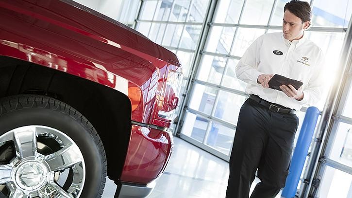 Service technician inspecting vehicle