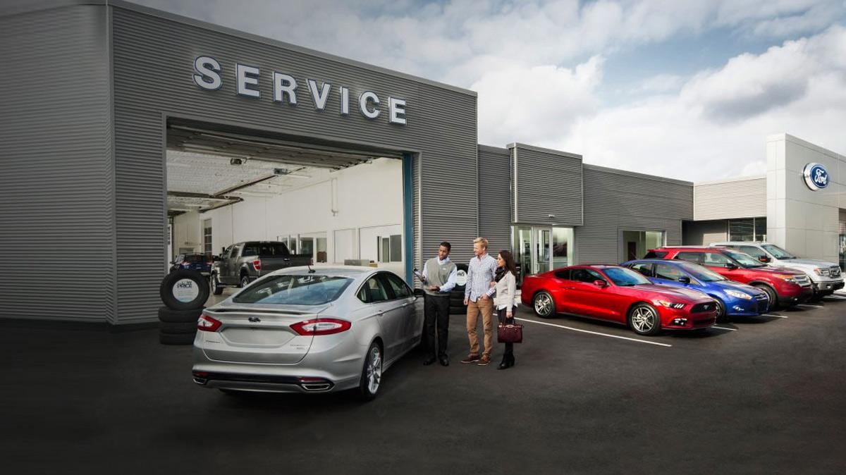 Service advisor with clients at a Ford Service Center