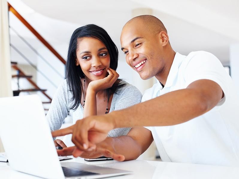 Couple looking at a laptop together