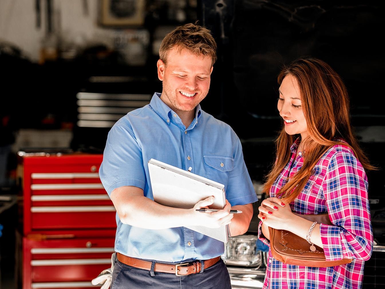 Platinum Ford Service Adviser talking with woman at service center