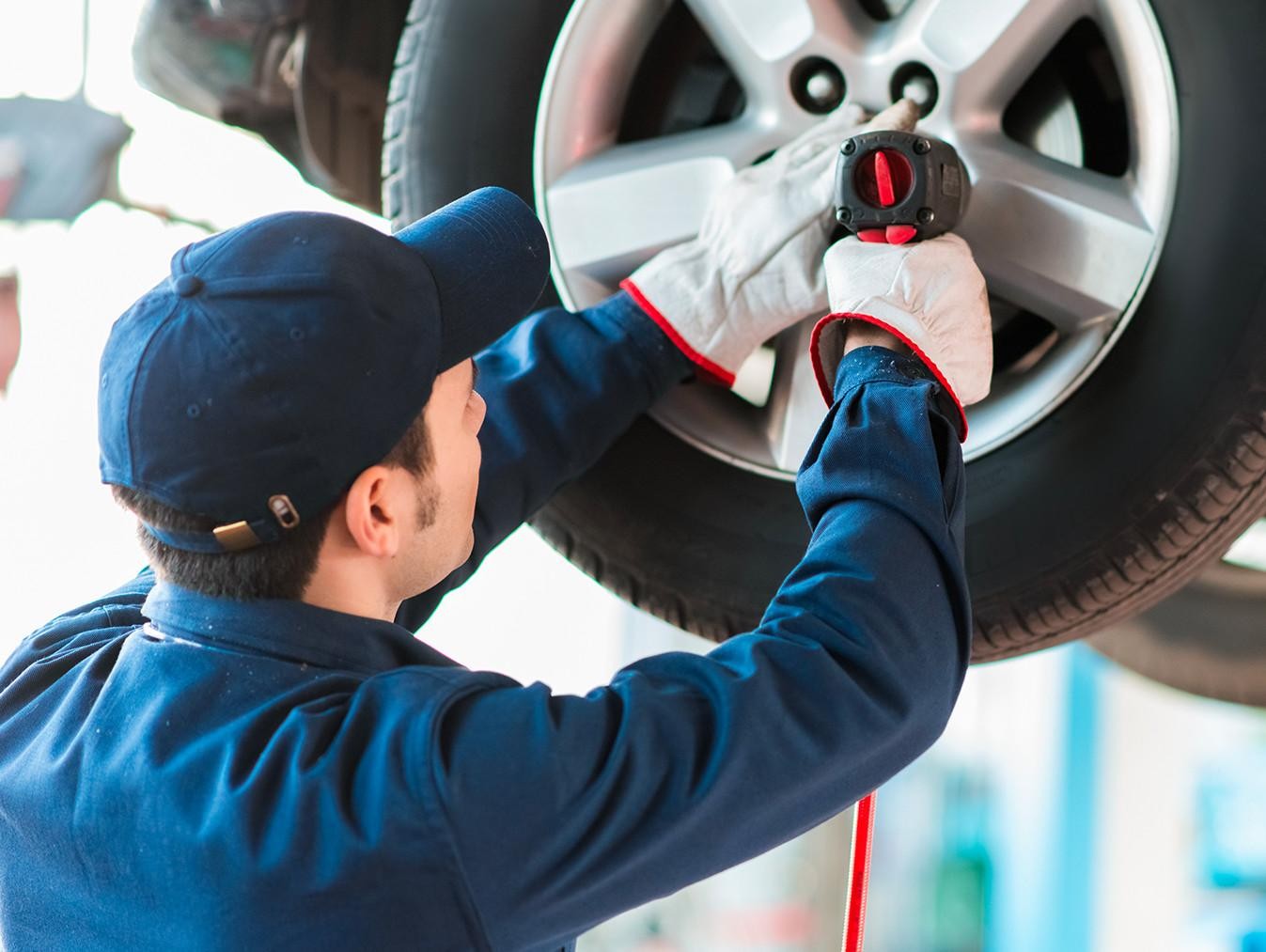 Ford service technician replacing a tire