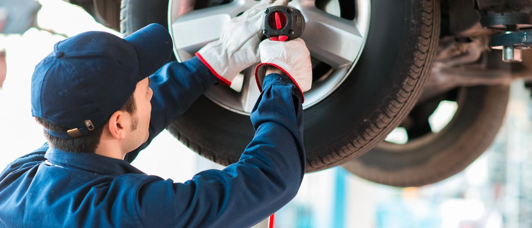 Ford service technician replacing a tire