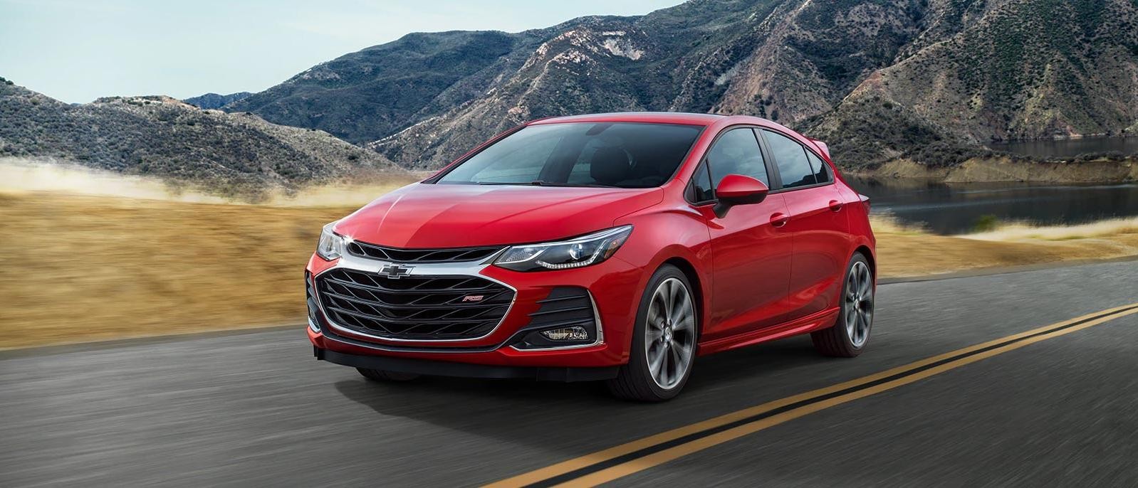 A Red 2019 Chevy Cruze driving on a highway.