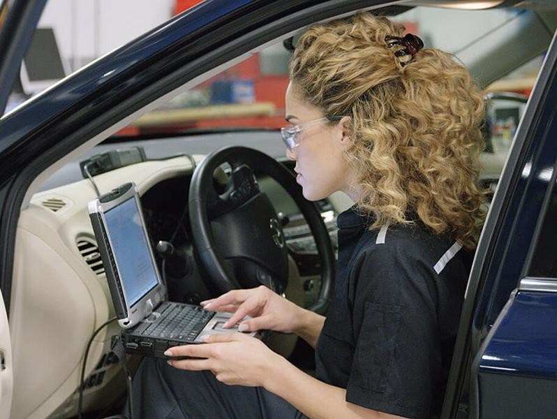 INFINITI Service Technician inspecting vehicle