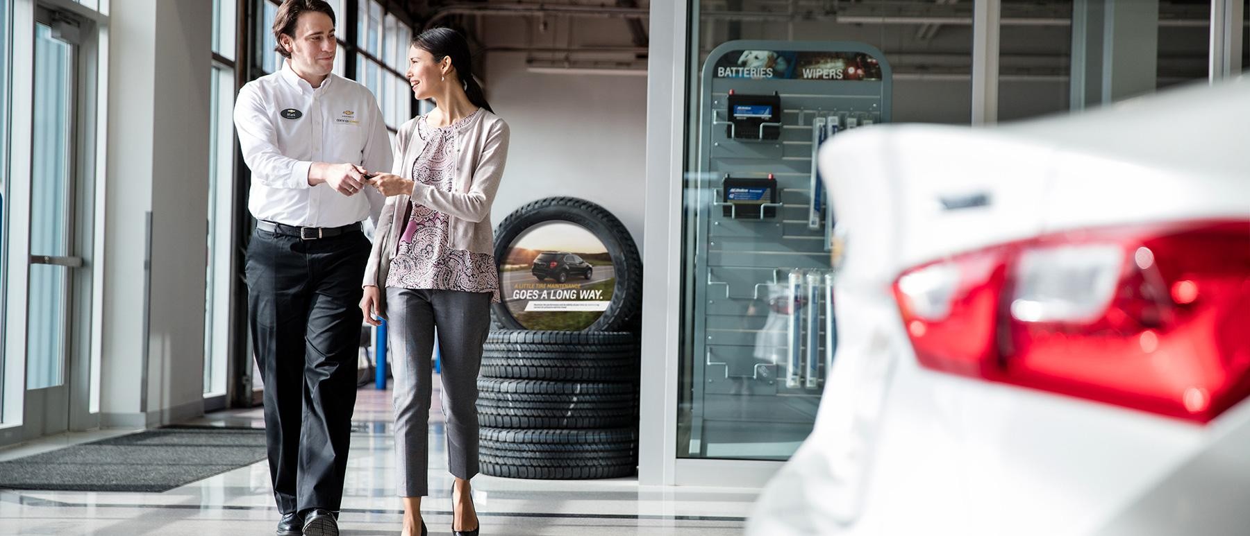 Chevrolet Certified Service Employee handing keys to women.