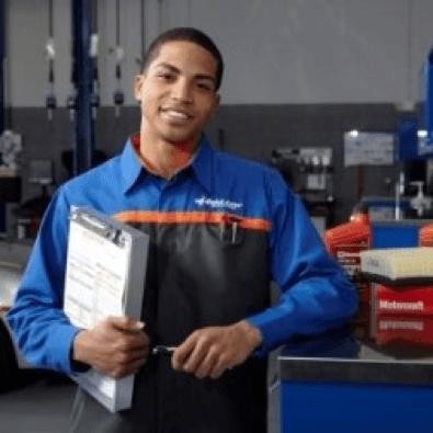 Service tech standing next to desk and smiling