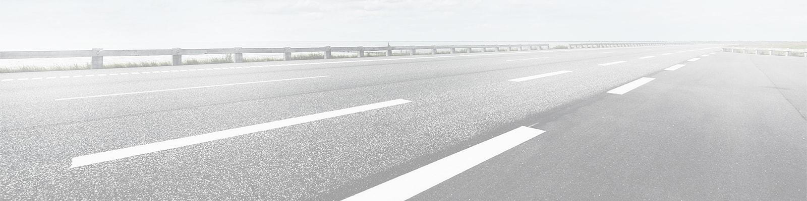 Closeup of a highway under a blue sky