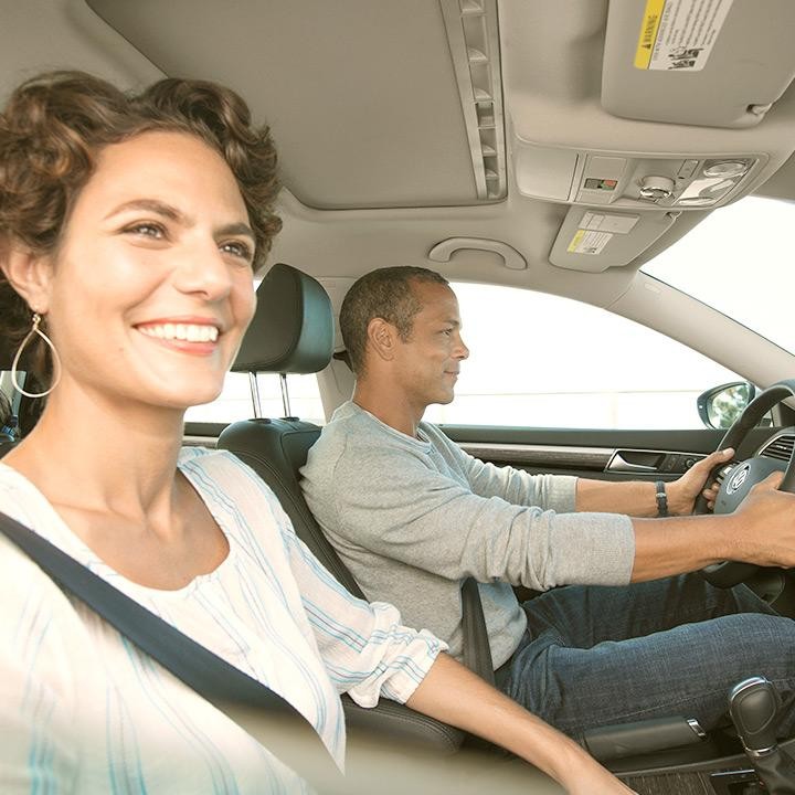 Happy couple inside Volkswagen vehicle