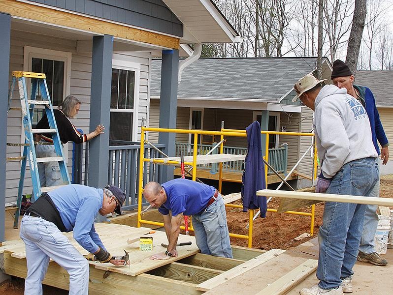 Staff doing volunteer work at a Habitat for Humanity construction site.