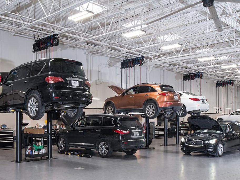 Infiniti technician performing diagnostics on vehicle.