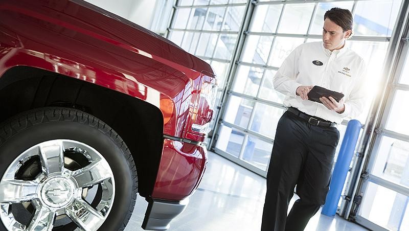 Service technician inspecting vehicle