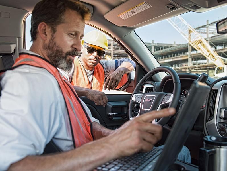 Construction worker sitting in GMC truck