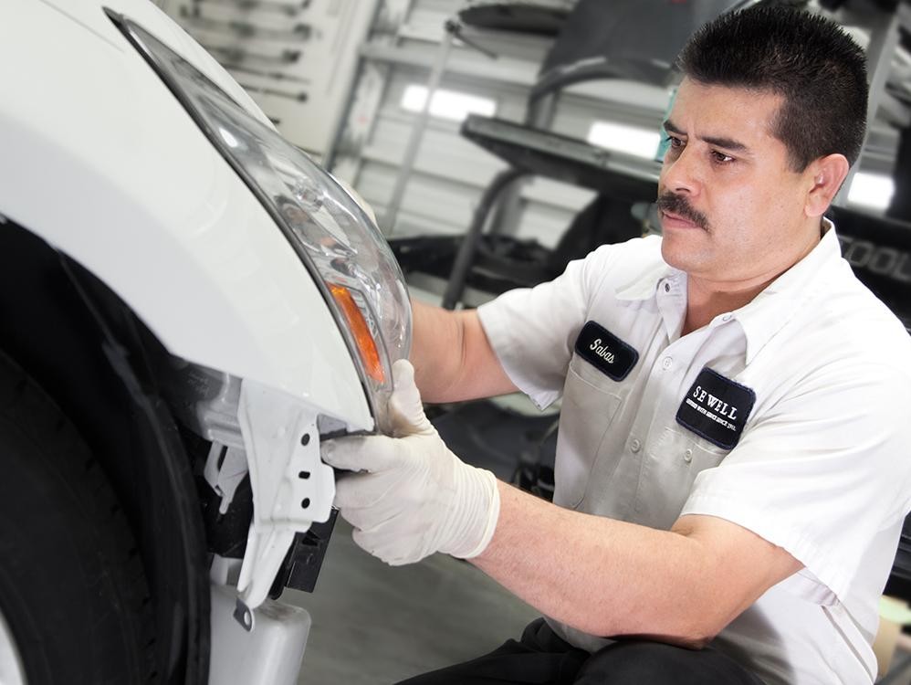 Sewell Technician repairing a white vehicle