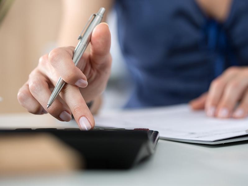 Woman using calculator