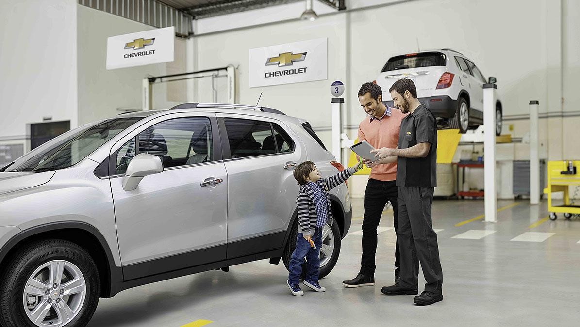 Father and son talking to service technician