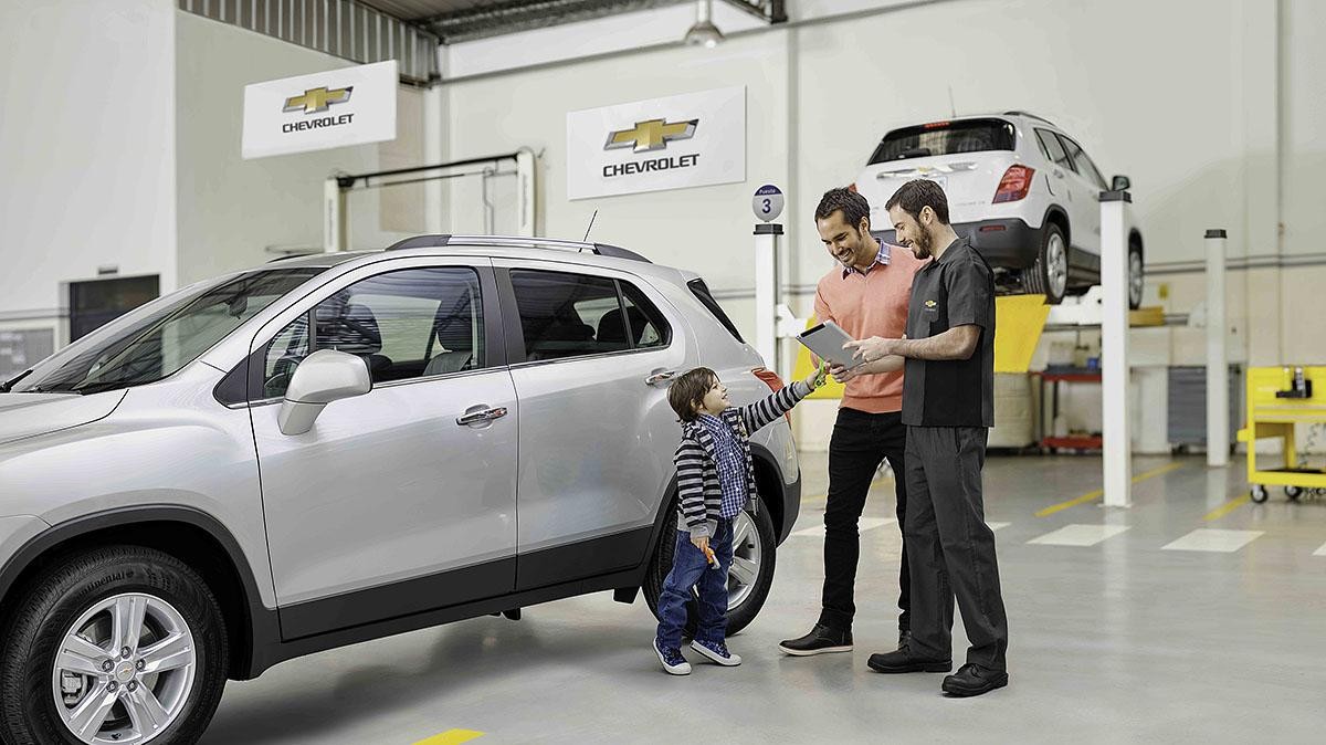 Father and son talking to service technician