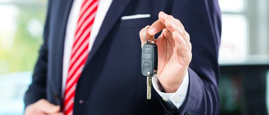 Cadillac Dealer Junction City KS Salesman Handing Keys