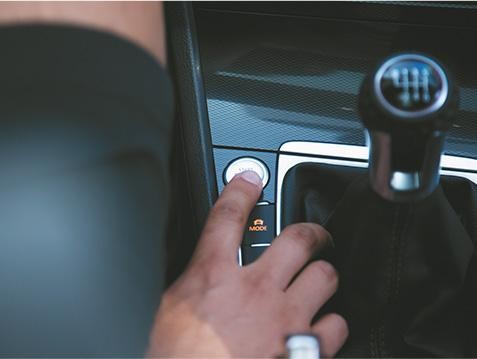 Close-up image of driver pressing Start Now ignition button. 