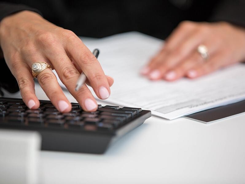 Sewell Finance Associate working at a computer