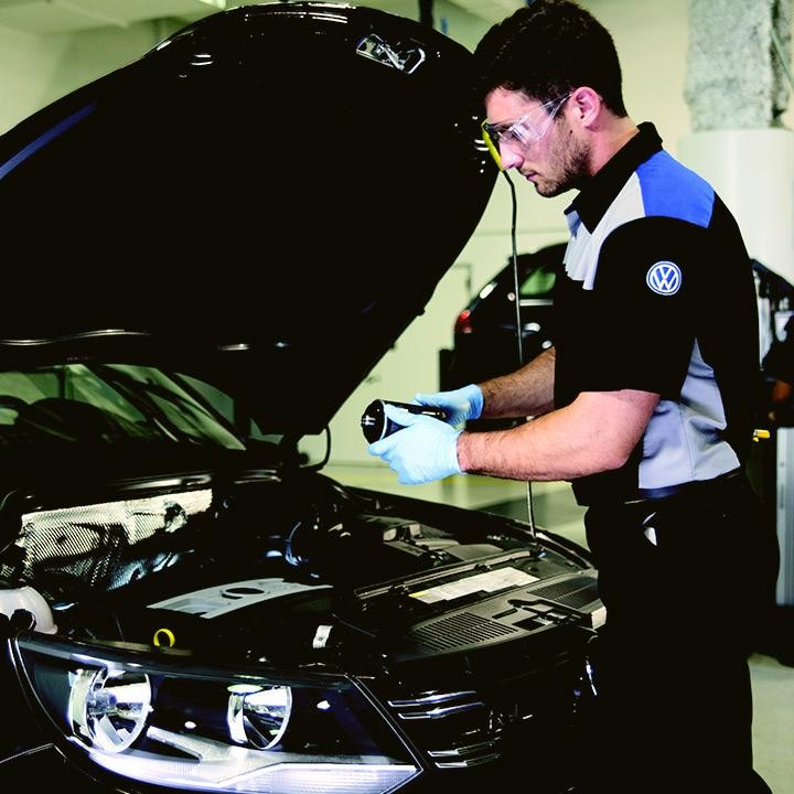 Volkswagen service technician working on vehicle