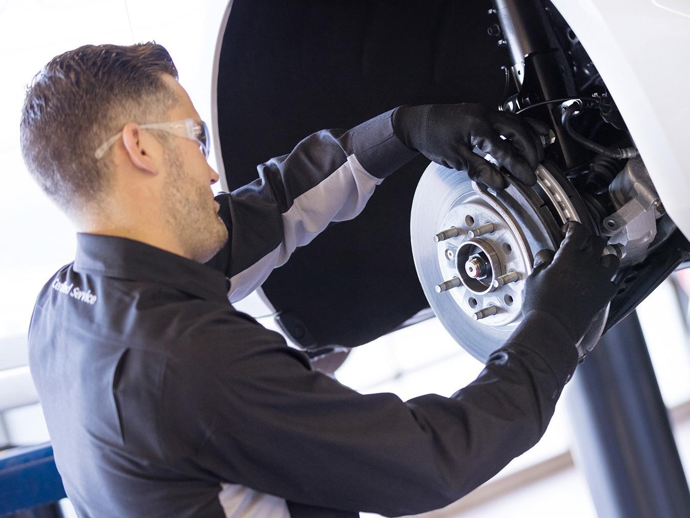 Service technician changing brake pads