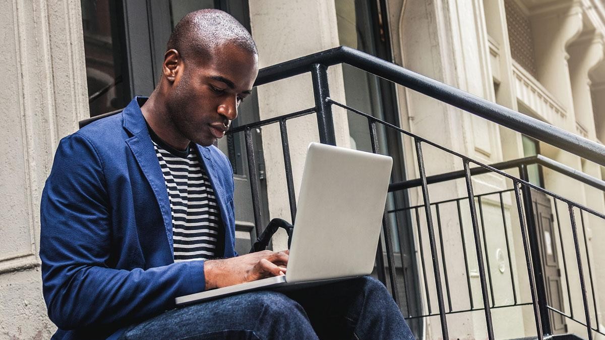 Man on stairs shopping online.